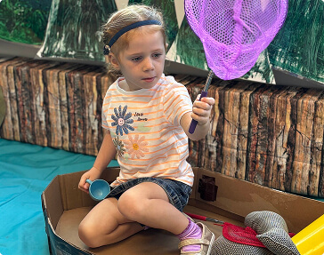 girl playing with butterfly net